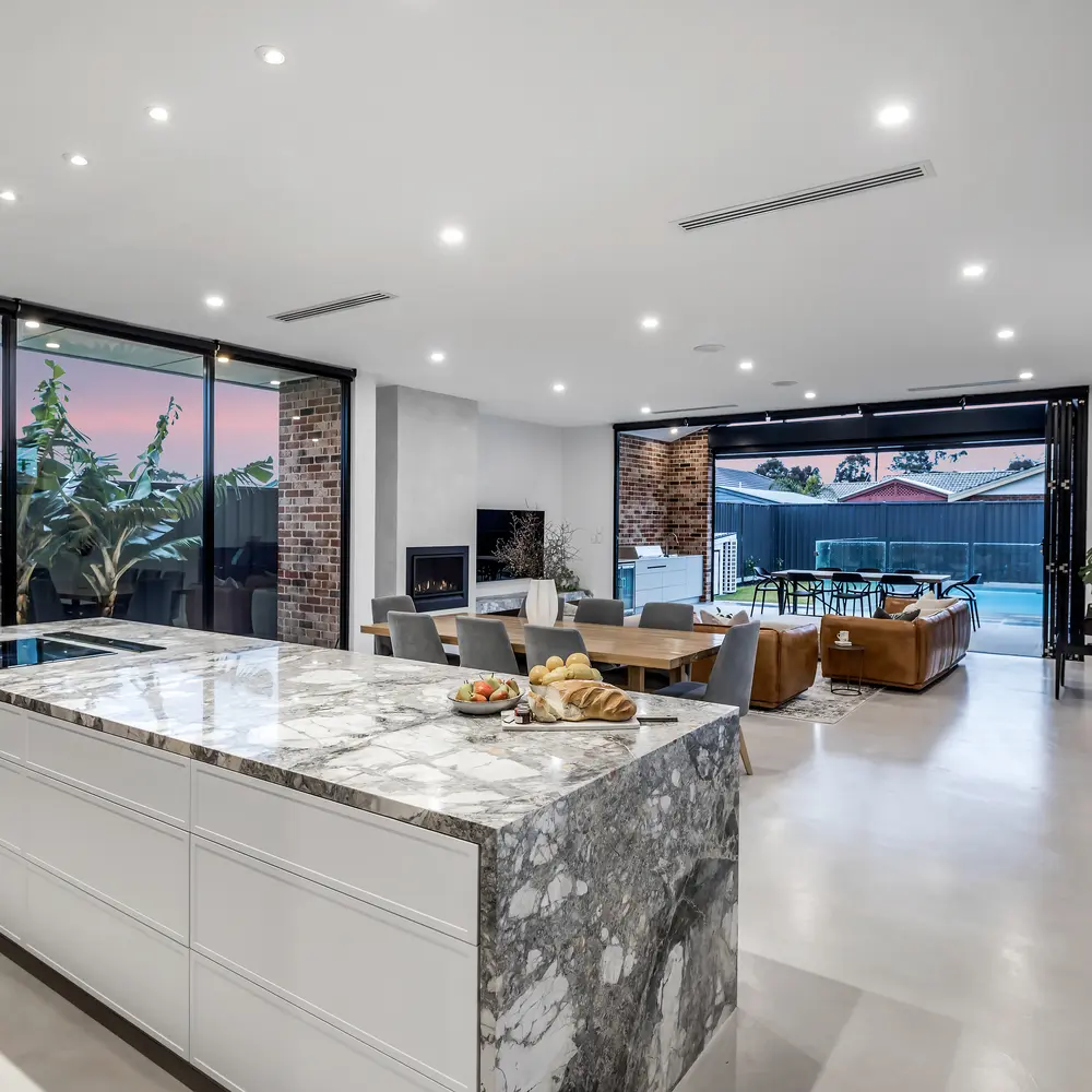 The living area of a home with a clean interior and marble countertop.