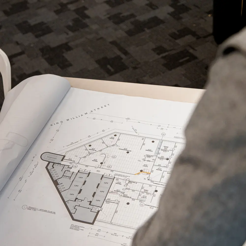 Workers looking at a floorplan